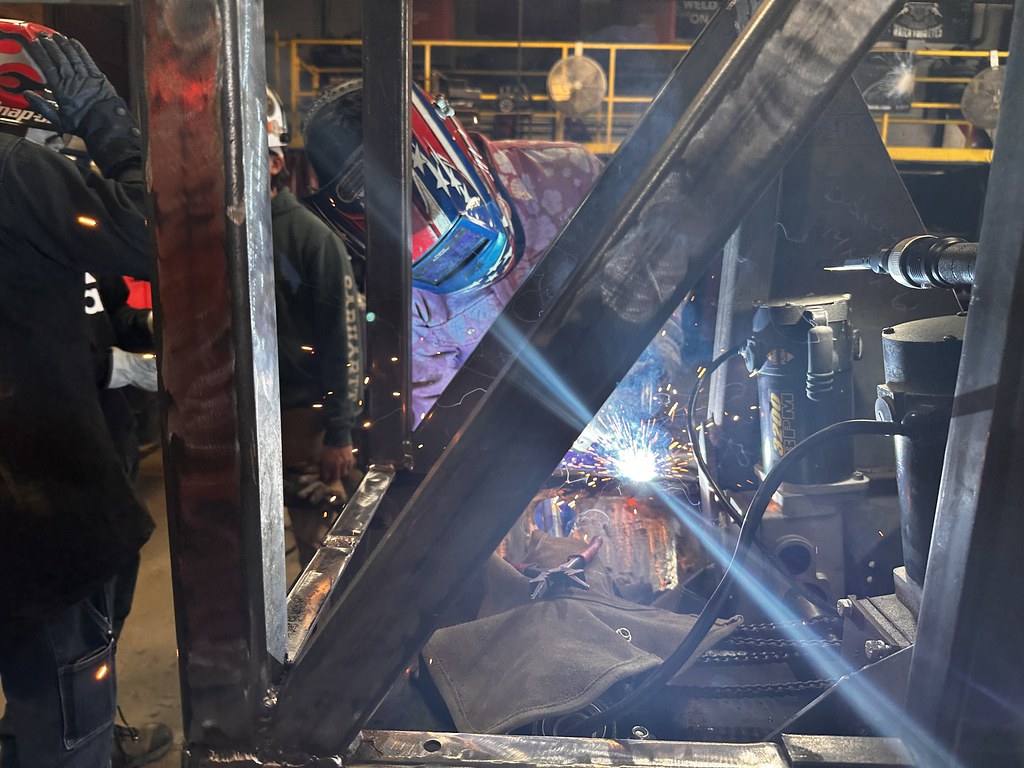 FundEDU | Tax Credit Scholarship Experts | Johnson College Receives EITC Contribution from Honesdale National Bank Student welding a steel frame in a technical training shop