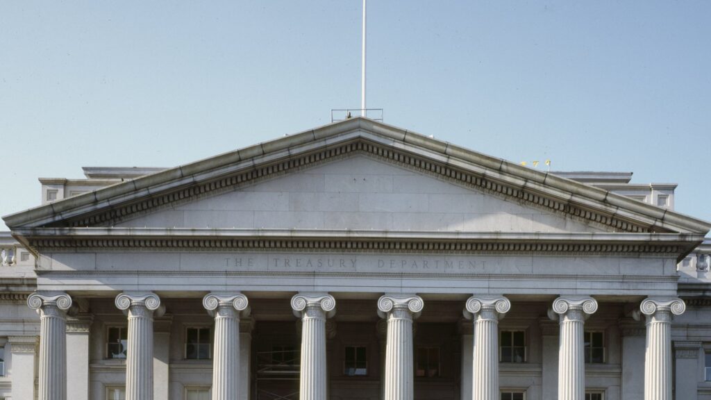 The columns and pediment of the U.S. Treasury Building in Washington, D.C., with "The Treasury Department" carved above the columns.